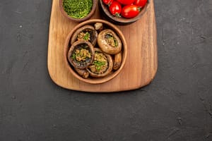 <a href="https://www.freepik.com/free-photo/top-view-tasty-cooked-mushrooms-with-tomatoes-dark-floor_13458392.htm#query=Mushroom%20and%20Spinach%20Stuffed%20Portobello%20Mushrooms&position=1&from_view=search&track=ais">Image by KamranAydinov</a> on Freepik