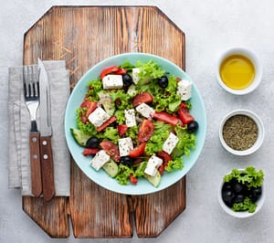 Image by <a href="https://www.freepik.com/free-photo/top-view-salad-with-feta-cheese-cutting-board-with-olives_10413192.htm#query=greek%20salad%20and%20tofu&position=1&from_view=search&track=ais">Freepik</a>